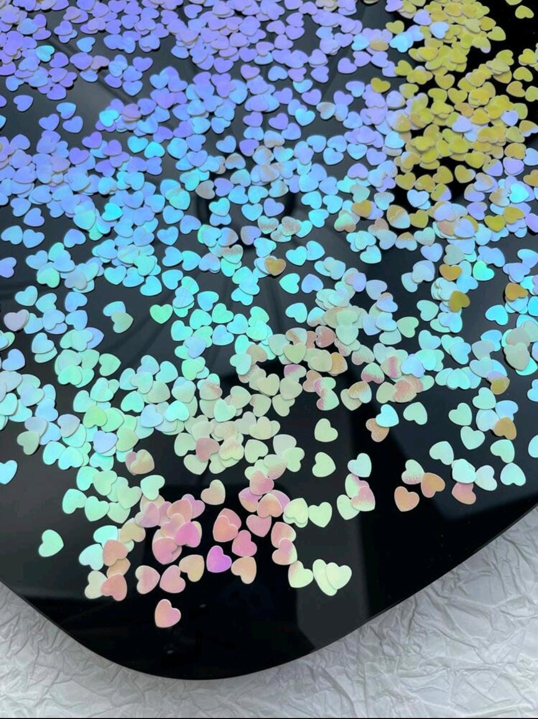 Holographic heart throwing confetti